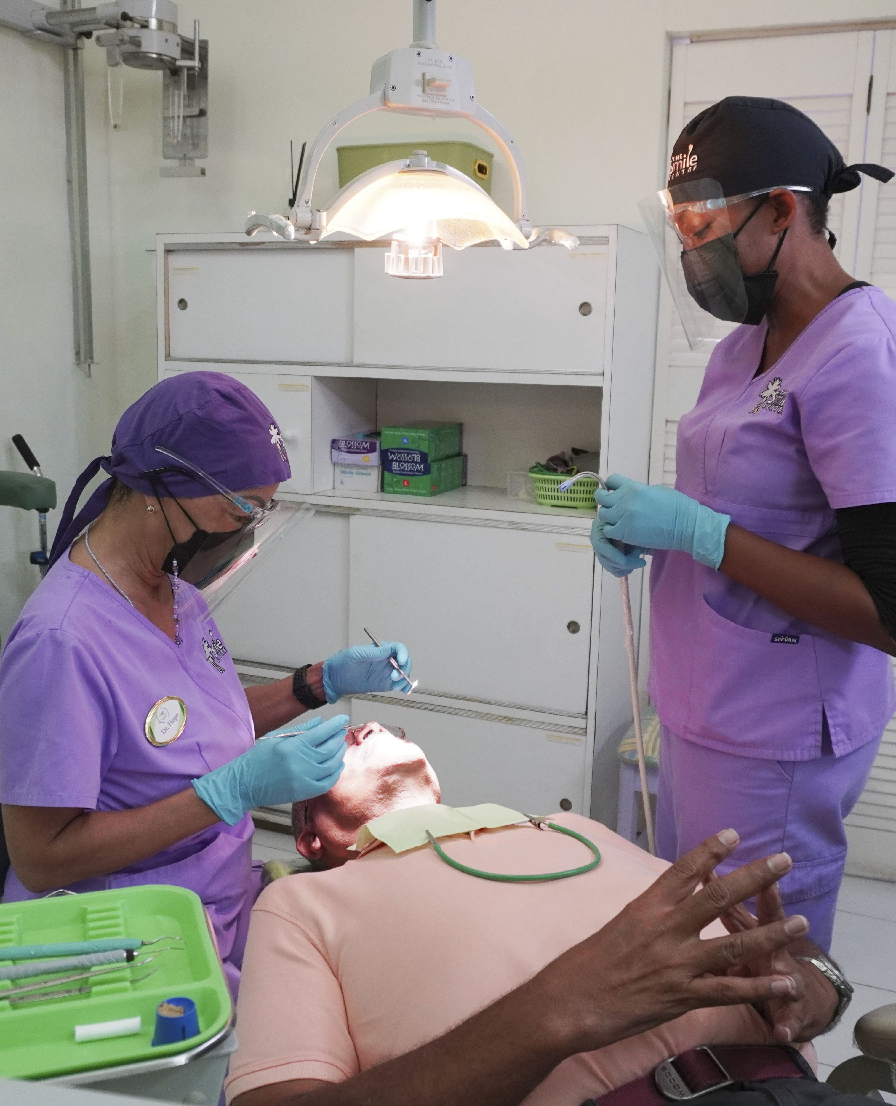 Dr. Hope and dental technician attending to a patient