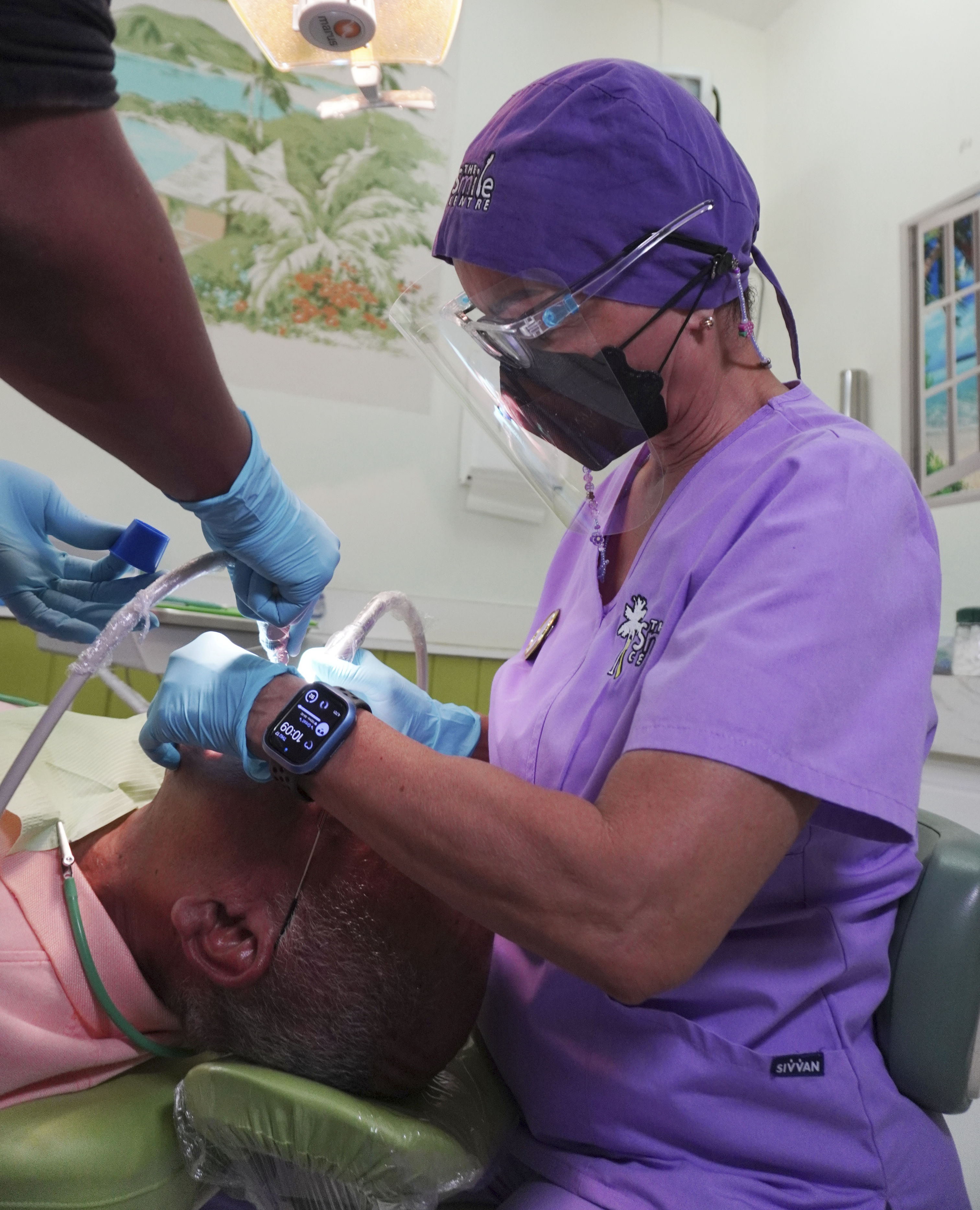 Dr. Hope and dental technician attending to a patient