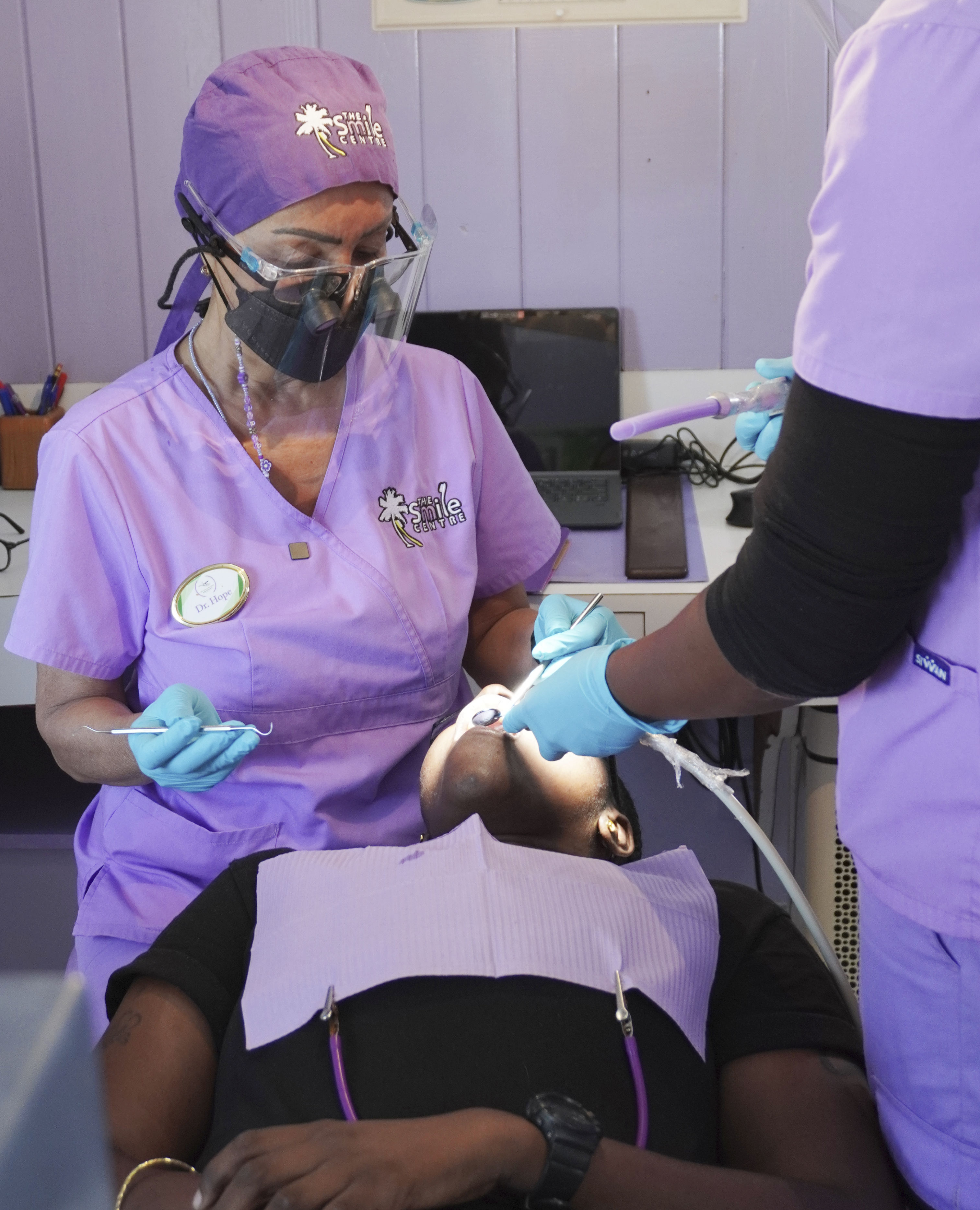 Dr. Hope and dental technician attending to a patient